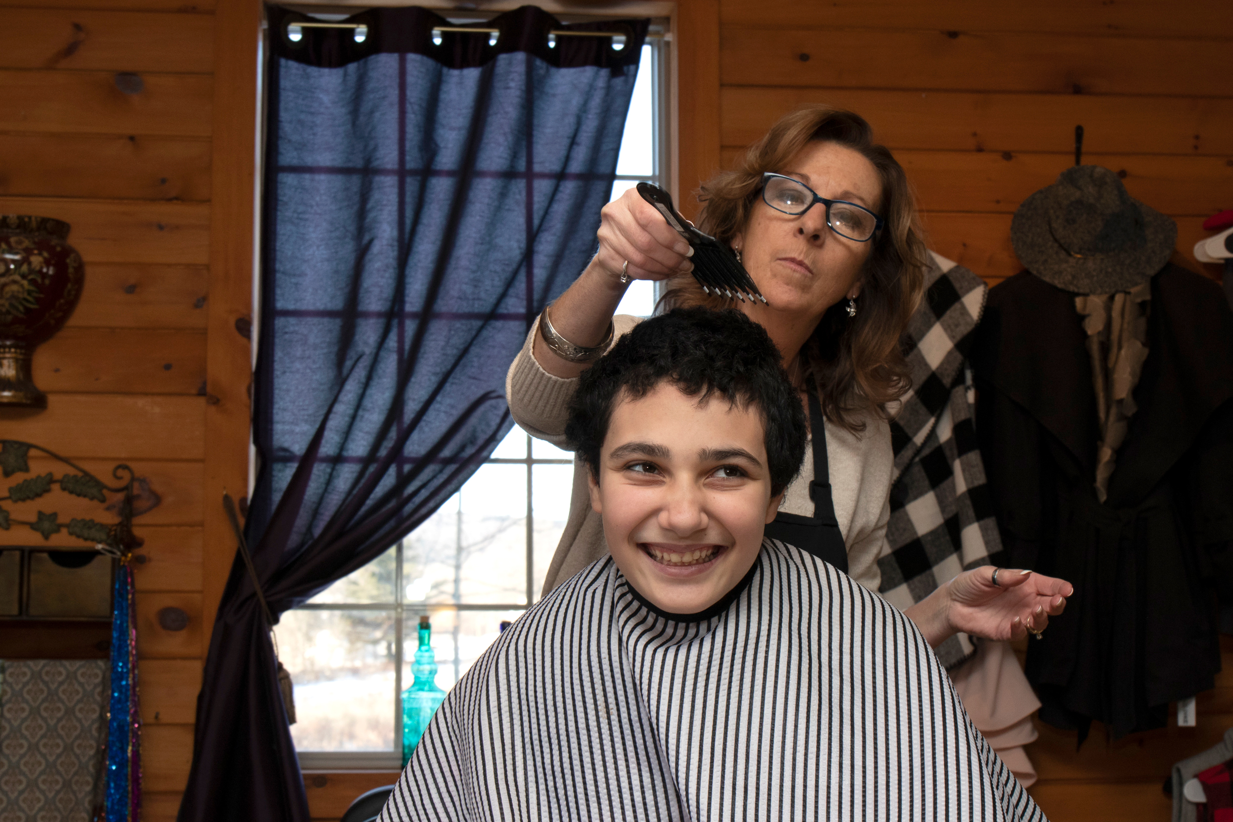 2020-JohnHaircut-Golisano (6) | Springbrook 06. After years of avoiding the barber’s chair, it appears that John might actually enjoy some parts of getting his hair cut. John smiled and voiced his approval as Donna combed his hair.